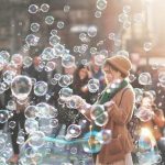 woman standing in a field of bubbles