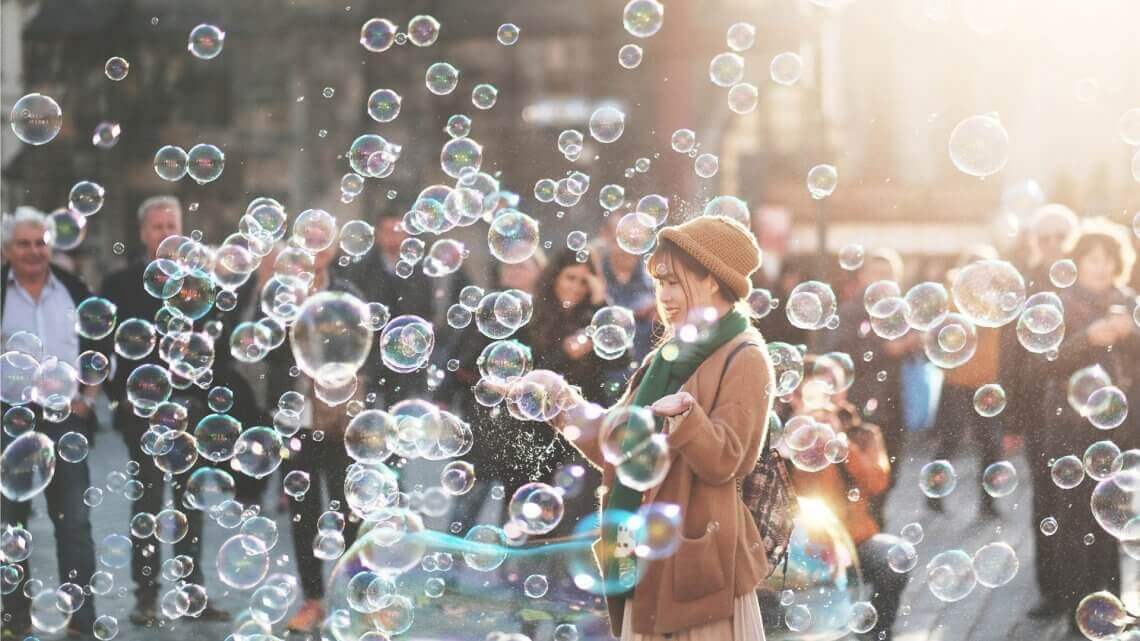 woman standing in a field of bubbles
